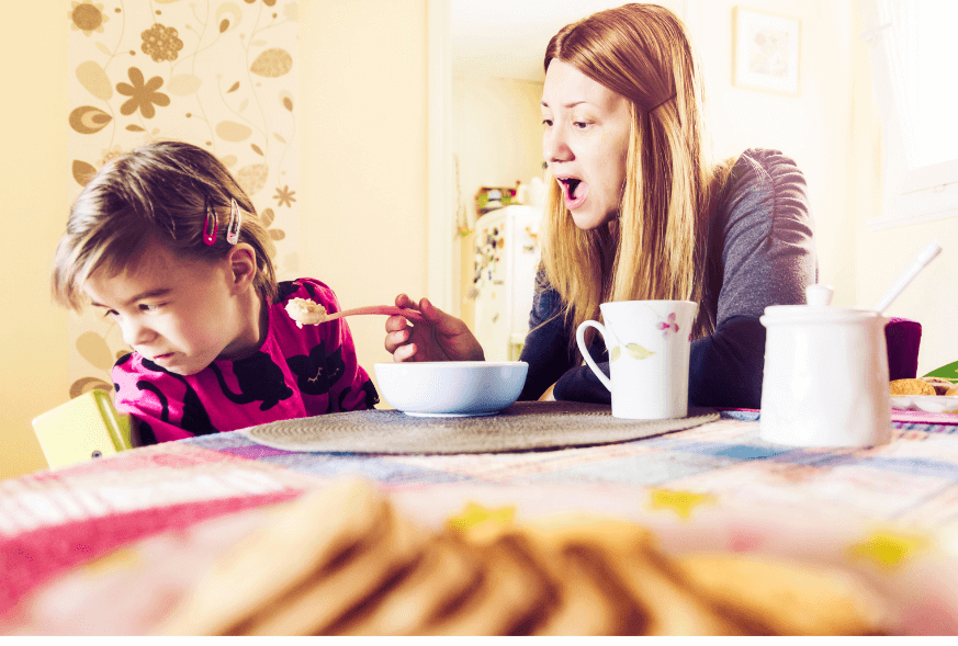 Child refusing food offered by parent